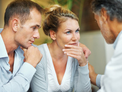 Couple talking to their doctor about fertility treatment options