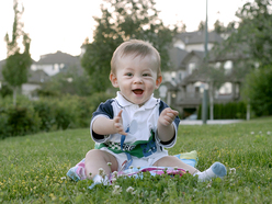 Little boy outside on the grass, clapping