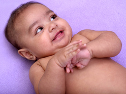 Happy baby lying on a blanket