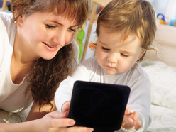 Mother and baby looking at an iPad