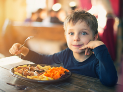 Boy sitting at dinner table