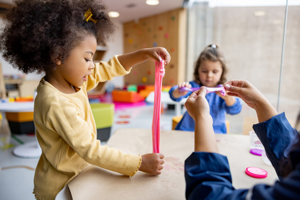 Girls playing with slime in class at the school