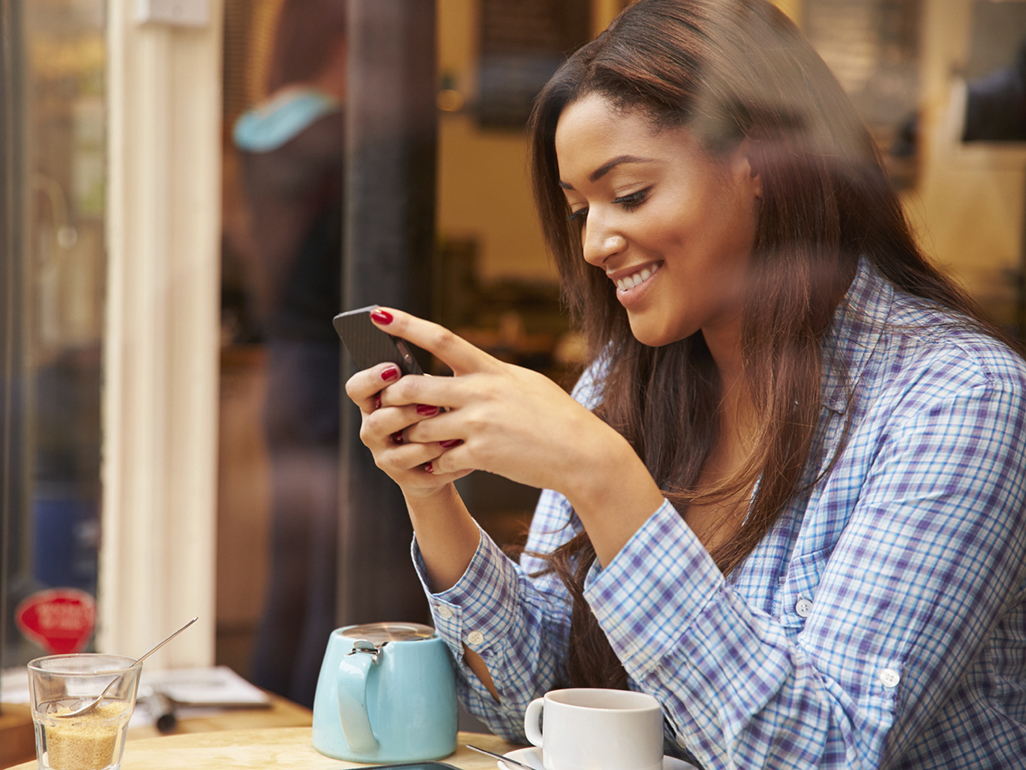 woman typing on her cell phone