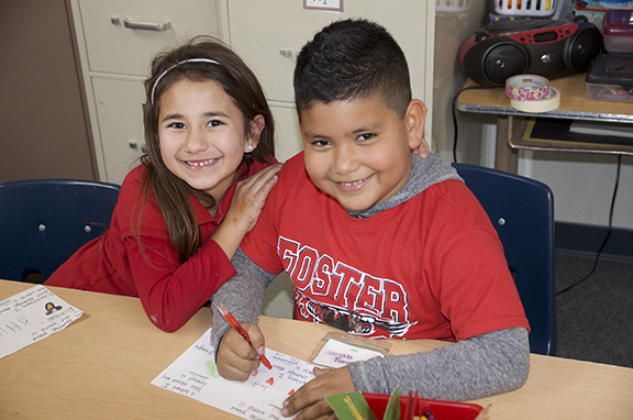 Two expanded learning students sitting at a desk.