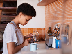 woman in the kitchen preparing a coffee