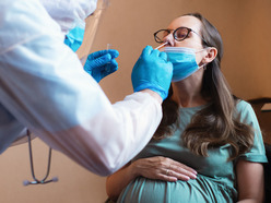 pregnant woman getting COVID swab