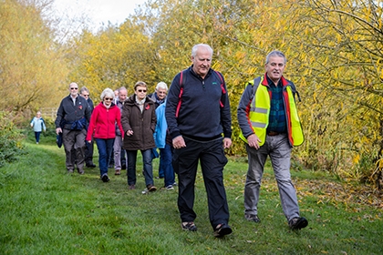 A group of people walking together through a park.