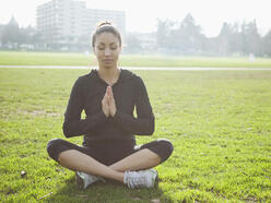 Woman doing yoga in park