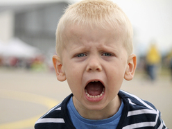 Young boy shouting angrily