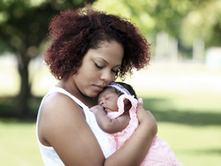 Mum comforting crying baby