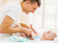 Dad changing baby’s diaper