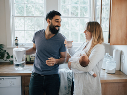 Mom and dad in kitchen with new baby