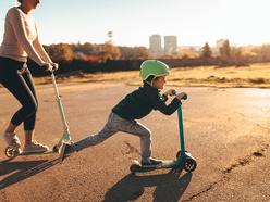 Young child riding on a scooter