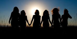 silhouette of a group of teen girls holding hands