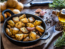 Cooked potatoes in an iron karahi