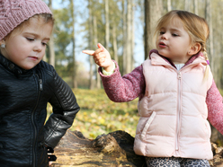 Two young children arguing outdoors