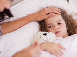 Young girl unwell in bed