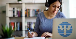 woman looking at laptop that has the APA logo on the back