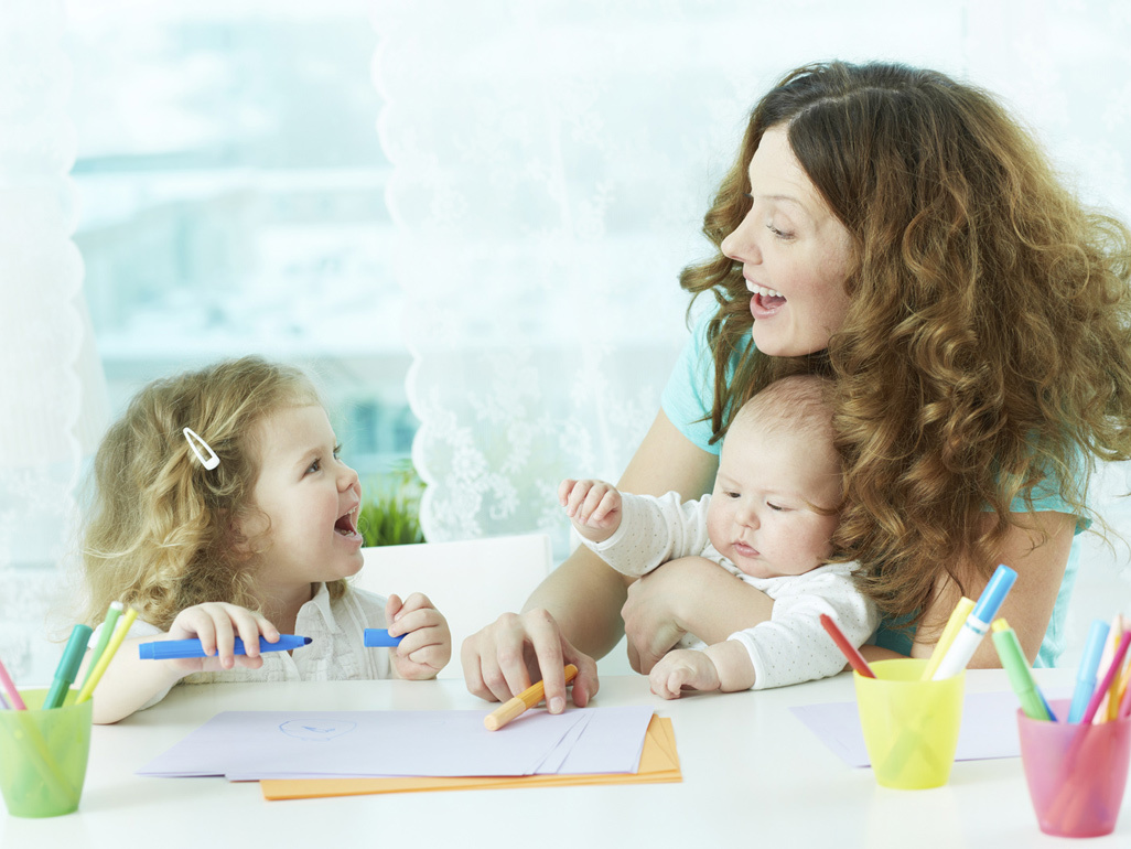 Carer with baby and toddler