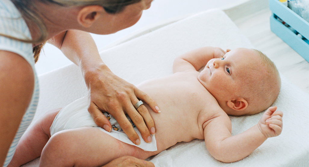 Mum changing her baby's nappy