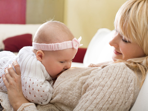 Woman reclining and breastfeeding baby