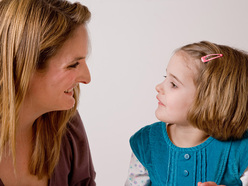 Mom and daughter smiling at each other