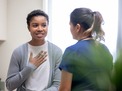 Woman speaking with nurse