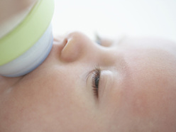 baby feeding from a bottle