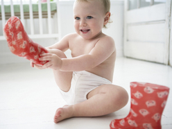 Toddler putting on her own clothes