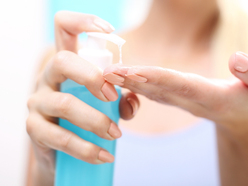 Woman pumping lubricant onto her fingertips