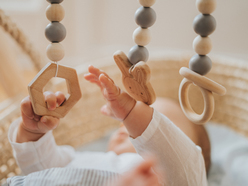 baby reaching and grabbing dangling toys