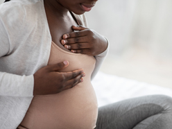 pregnant woman holding breast