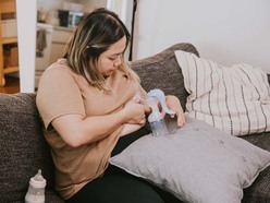 Woman expressing milk with breast pump