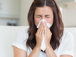 woman blowing her nose