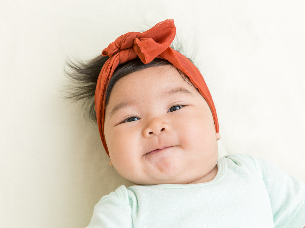 A baby girl with red headband