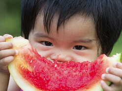 Toddler eating a green apple.