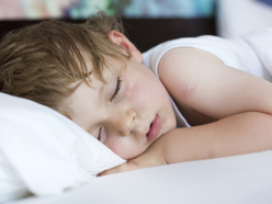 Little boy fast asleep with flushed cheeks