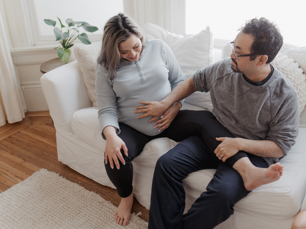 pregnant woman and partner rubbing her belly