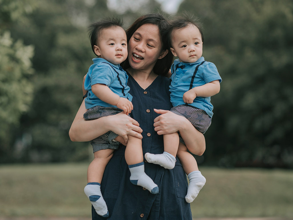 A mom holding two twin boys