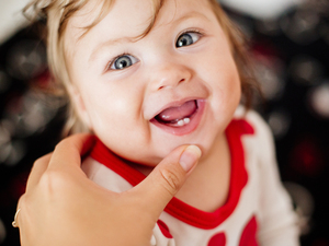 smiling baby showing two teeth