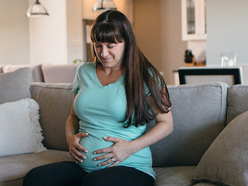 pregnant woman in pain, holding her belly