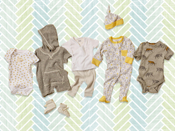 multiple baby outfits laid out on blanket