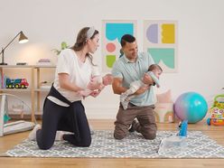 Instructor with baby and dad in playroom