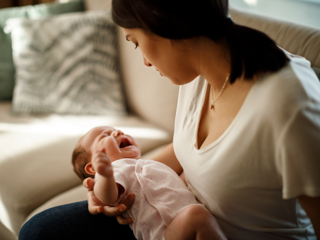 Mum holding crying baby