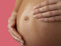 large pregnant belly showing belly button flattening