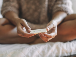 woman holding pregnancy test