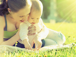 Mom and baby playing in the sunshine