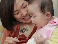 Mom feeding a baby