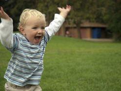 Little boy running in park