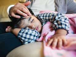 Child sleeping on parent's lap